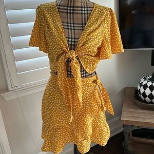 Two-piece cut off tie top with mini skirt